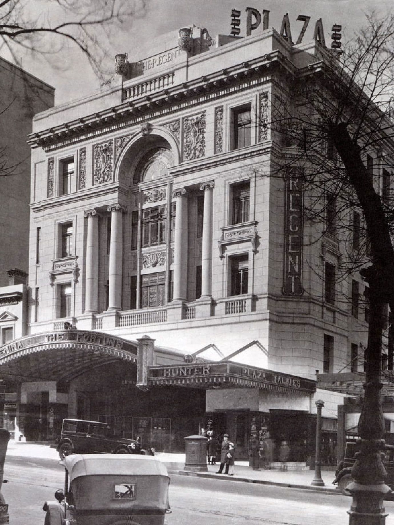 Vintage black and white photo of the grand Plaza building exterior with an arched entrance.
