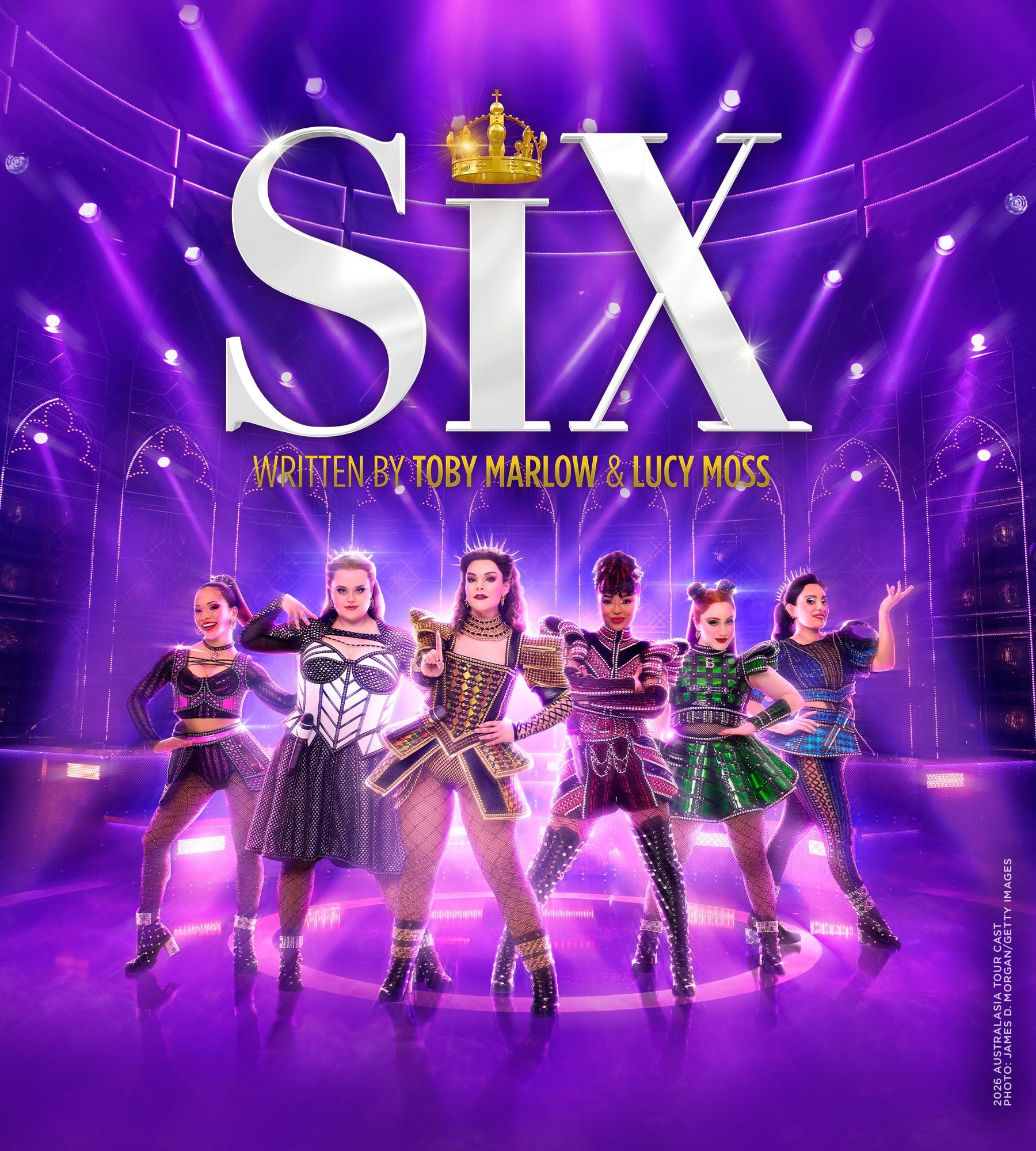 Six confident female performers in elaborate, historical-inspired costumes on a purple stage. Musical SIX.