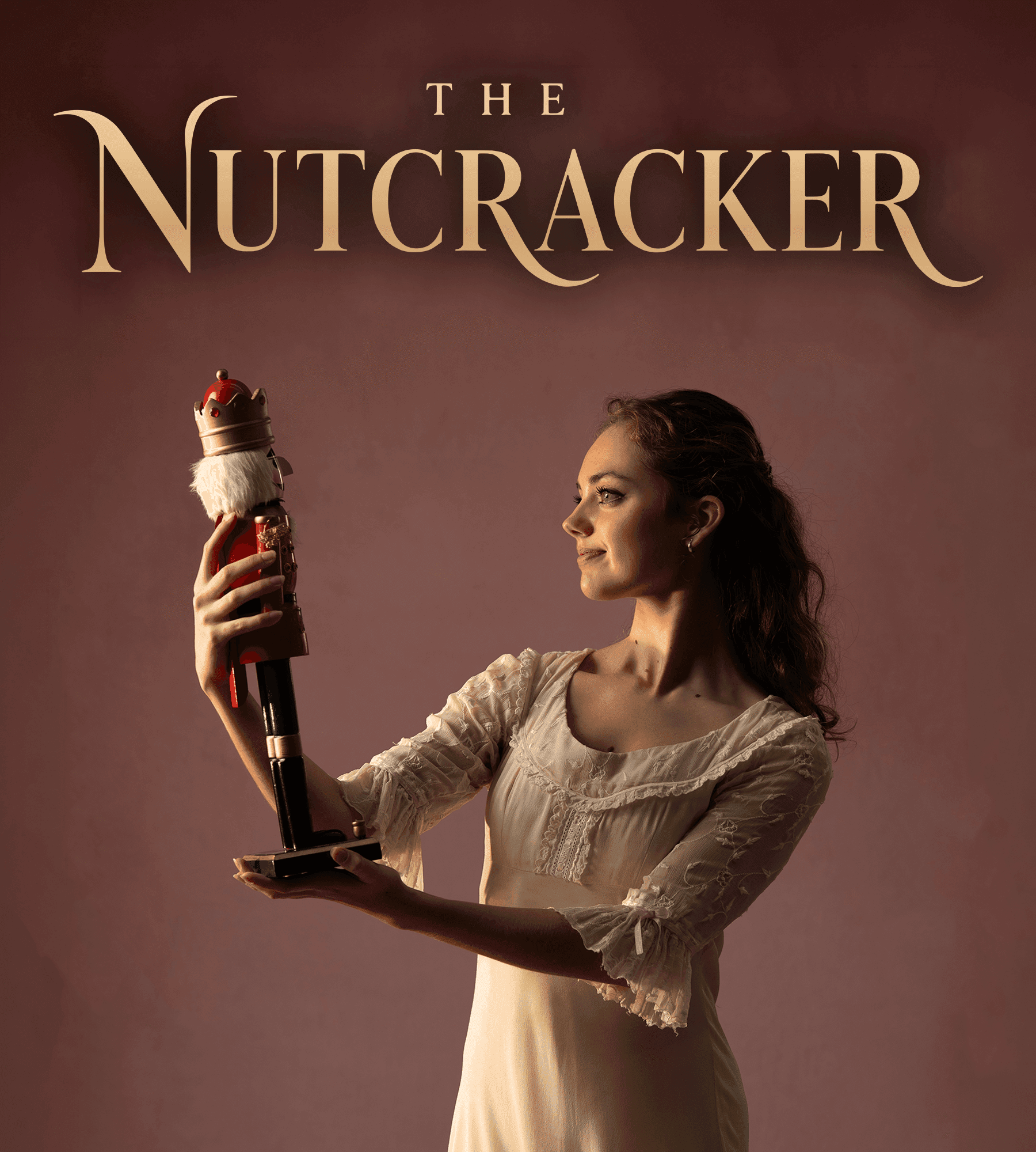 Ballerina in a white dress holds a Nutcracker doll under the title 'THE NUTCRACKER'.